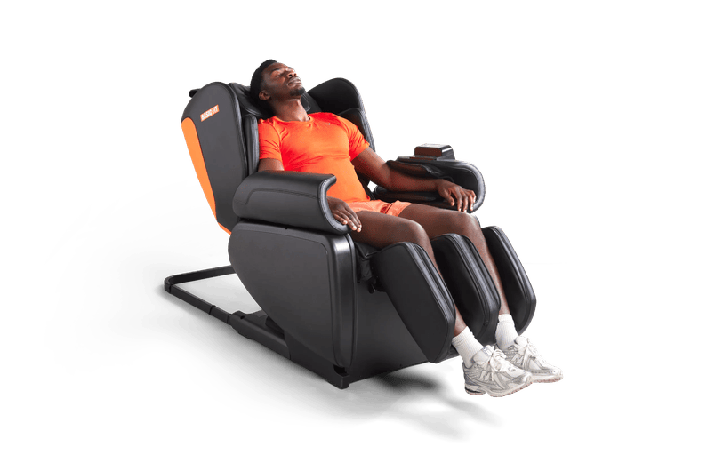 Man relaxing in a massage chair at Basic-Fit.